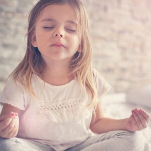 young girl meditating - connected kids foundation course teach meditation