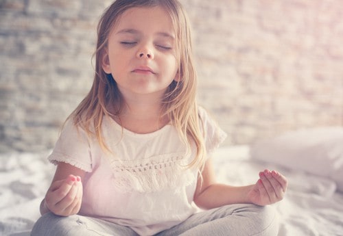 young girl meditating - connected kids foundation course teach meditation