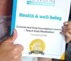 lorraine e murray, founder of connected kids holding gold award from nursery world for connected kids course to teach children meditation