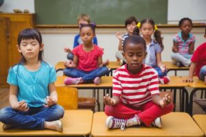 children learning meditation in school - accredited courses