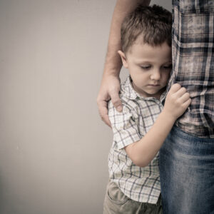 school transitions - boy hugging dad - mental health awareness month