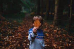 boy holding leaf autumn meditation ideas for kids and teens