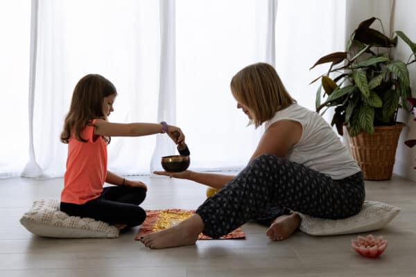 calm children teens with connected kids Lorraine E Murray, founder of Connected Kids helping young people learn meditation skills using a singing bowl