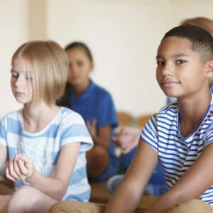 boy looking at camera - children meditation - educators resource mindfulness in schools