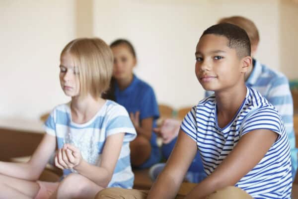 boy looking at camera - children meditation - educators resource mindfulness in schools