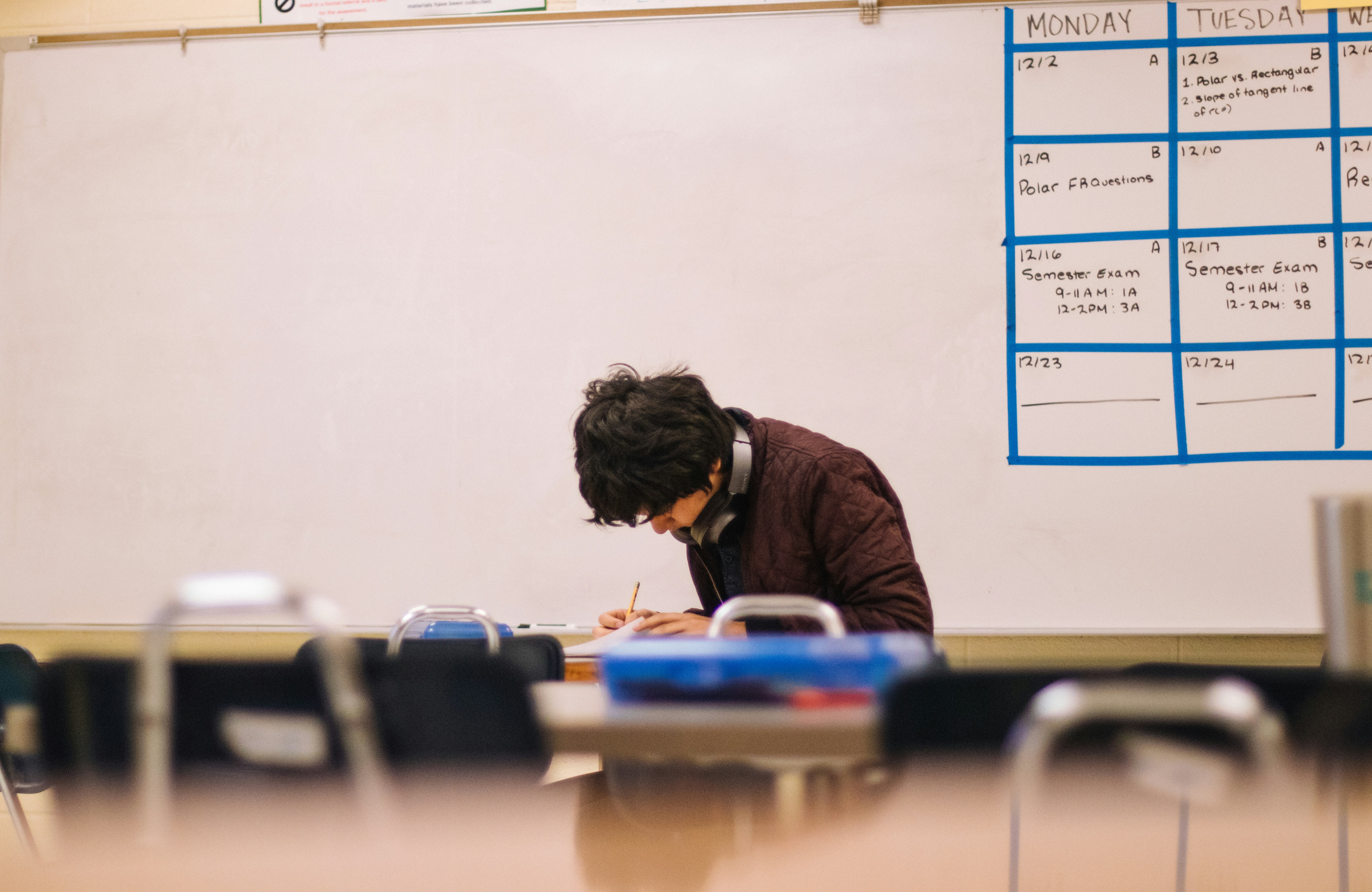 teacher at desk marking papers Teachers face relentless pressure—meditation can restore wellbeing and bring calm to the classroom.
