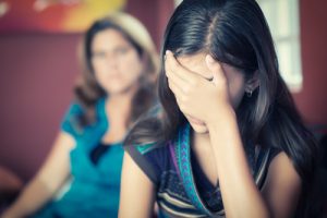 anxious girl head in hands - webinar on mindful skills to help